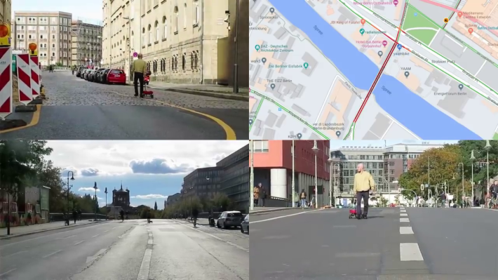 男子拖著小拖車和 99 部開著 Google Map 的手機，在沒有車的橋上行走， Google Map 上即顯示橋上交通擠塞（圖右上）。
